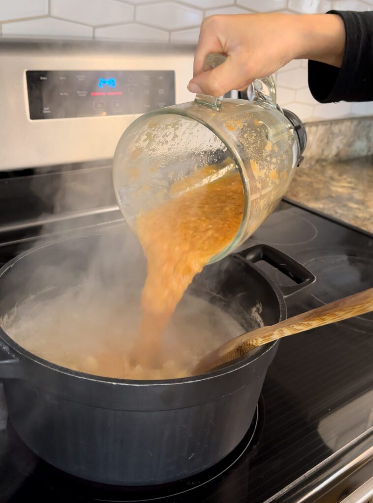 Adding tomato soup to a pot